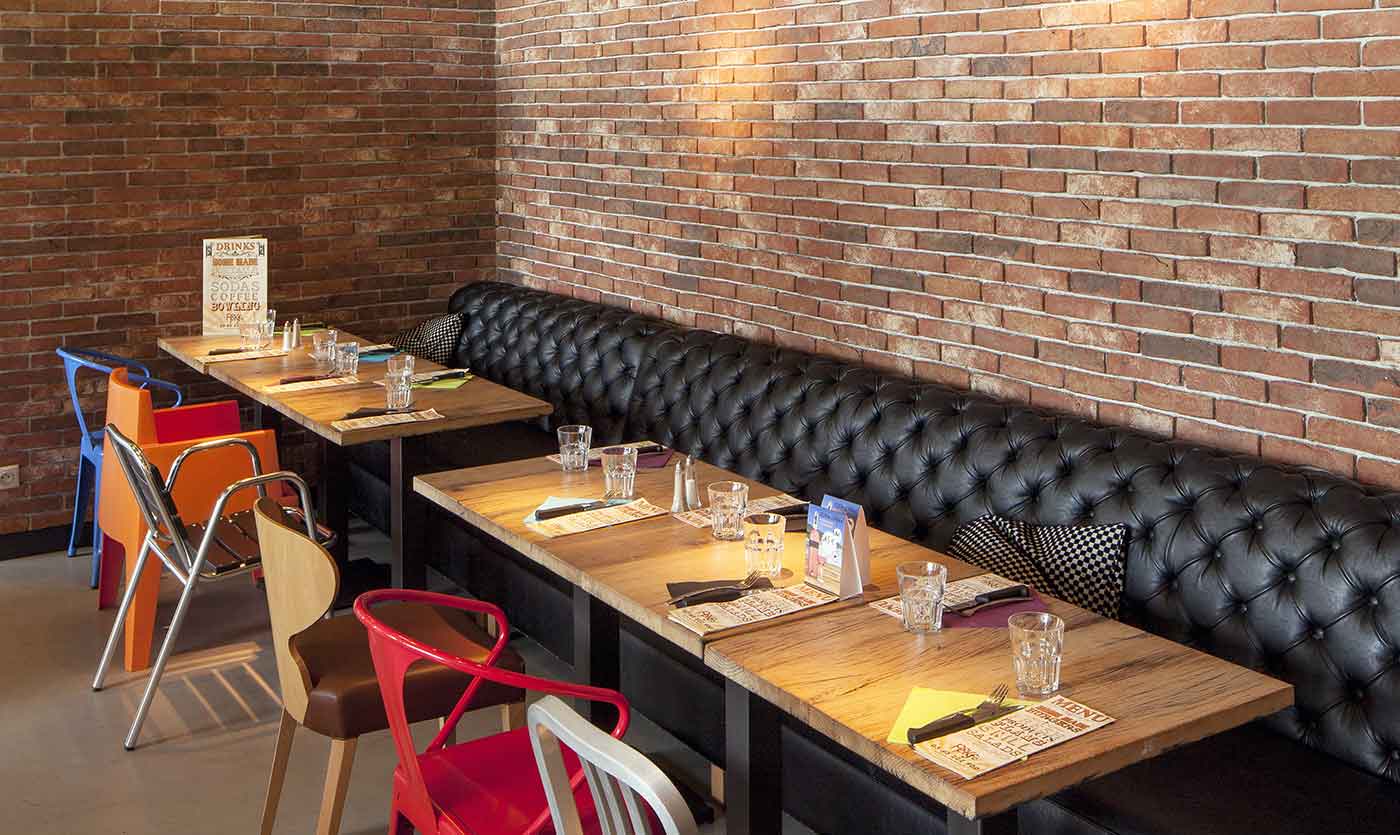 black chesterfield restaurant bench and tables popkfé